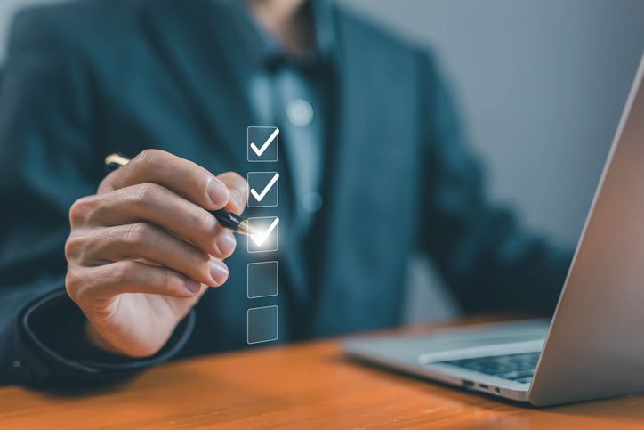 A man pointing out a checklist for LTL freight pallet prepared for shipment to avoid accessorial fees and reclassification charges